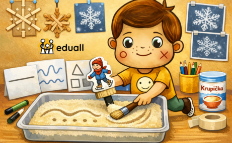 Edáček ve třídě mateřské školy kreslí do krupice pomocí štětce a bruslaře, zimní grafomotorická aktivita pro děti